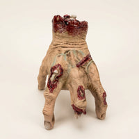 The Electric Walking Hand crawling across a candlelit haunted wood table View 1