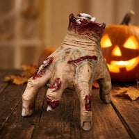The Electric Walking Hand ambush prop on a cobweb-covered haunted house shelf View 5