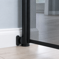 Close view of the retractable pet gate wall mount aligned over a baseboard View 15