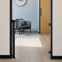 Retractable pet gate rolled into its wall post with the doorway clear View 14